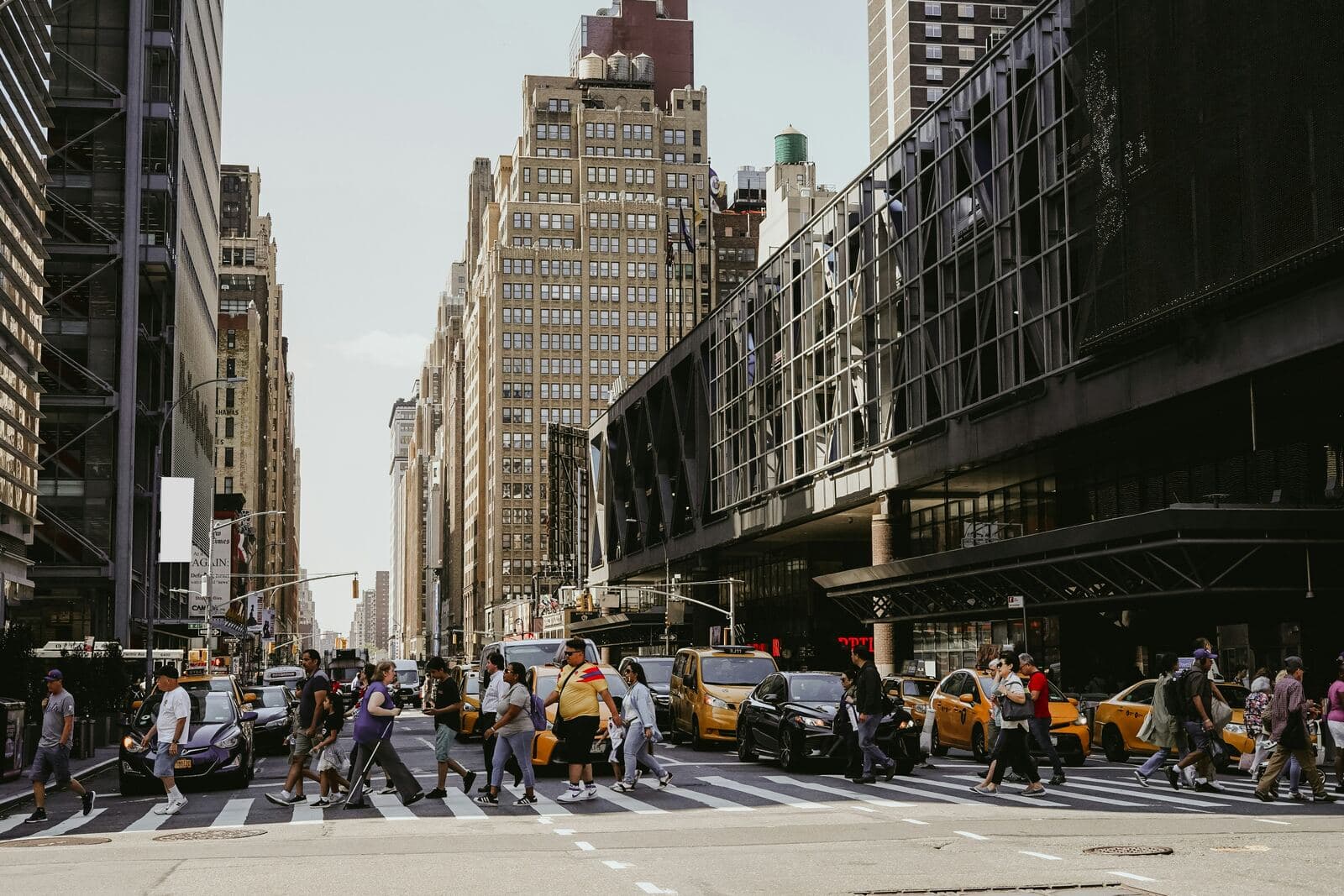 Busy street crossing among Manhattan skyscrapers